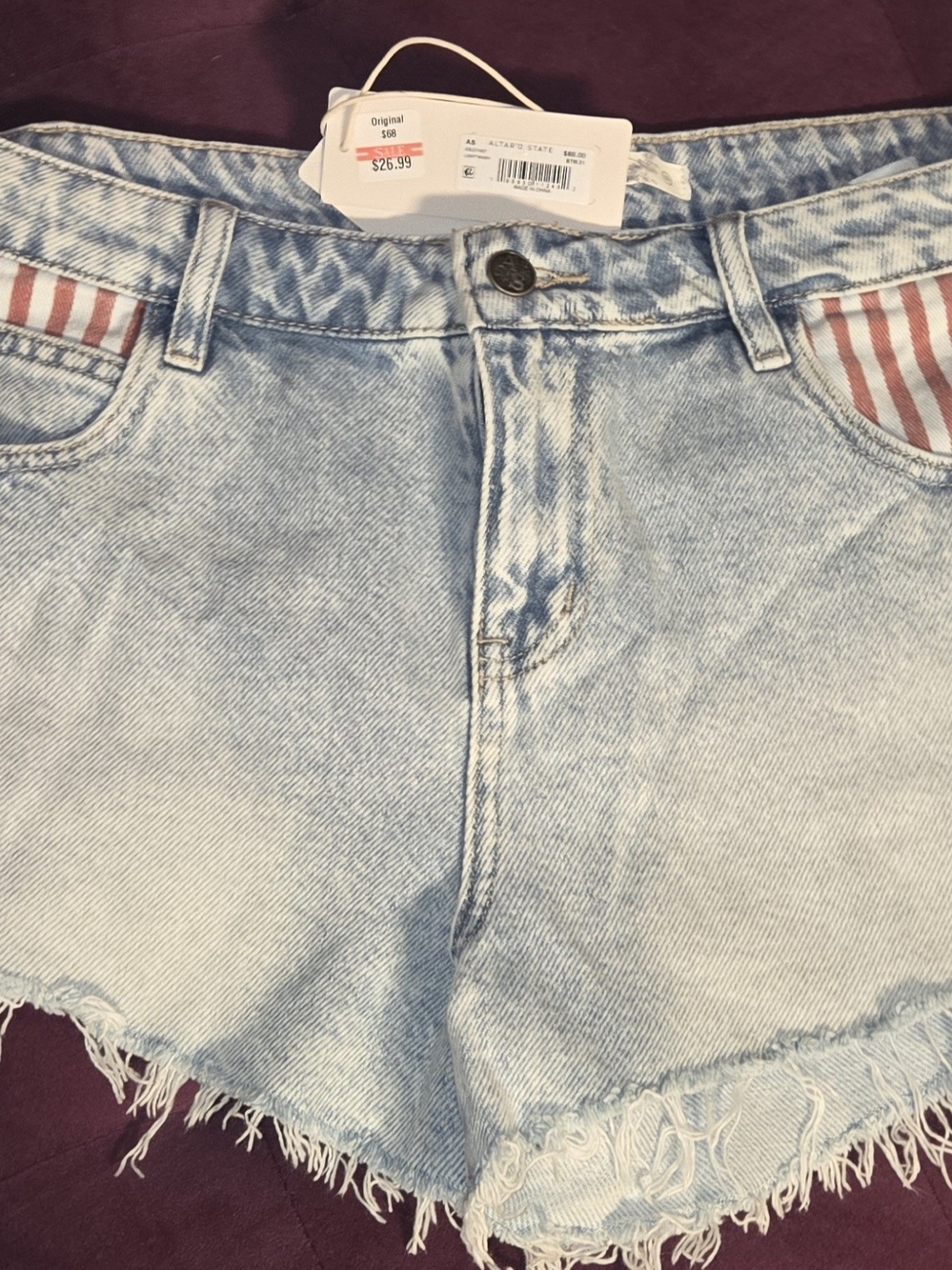 Altar'd State Light Wash Denim Shorts with Red-Striped Pocket Detail